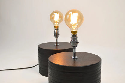 Black table lamp with a sleek modern design for home and office lighting.