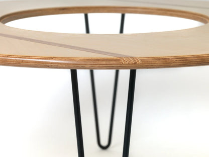 Handcrafted plywood coffee table with smooth curved edges and glass top.