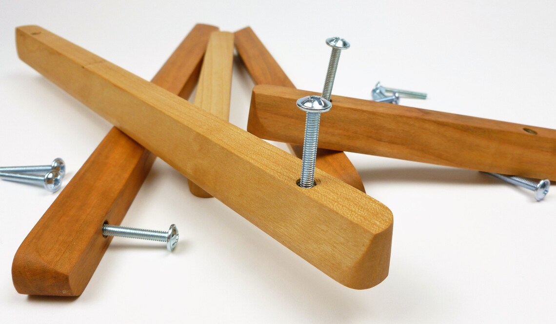 Elegant long cherry wood handles for wardrobes and drawers.