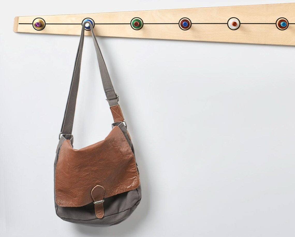 Mid-century modern wooden coat rack featuring durable aluminum hooks in a stylish design.