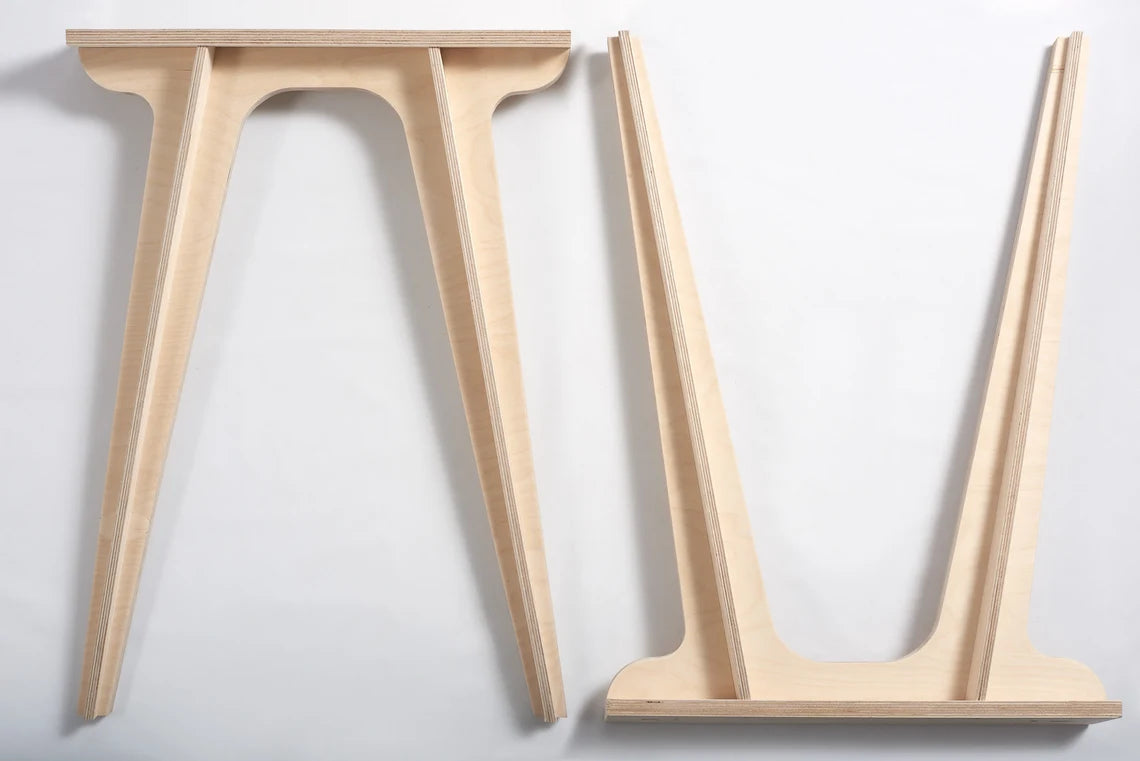 Wooden hairpin legs supporting a modern dining table setup.