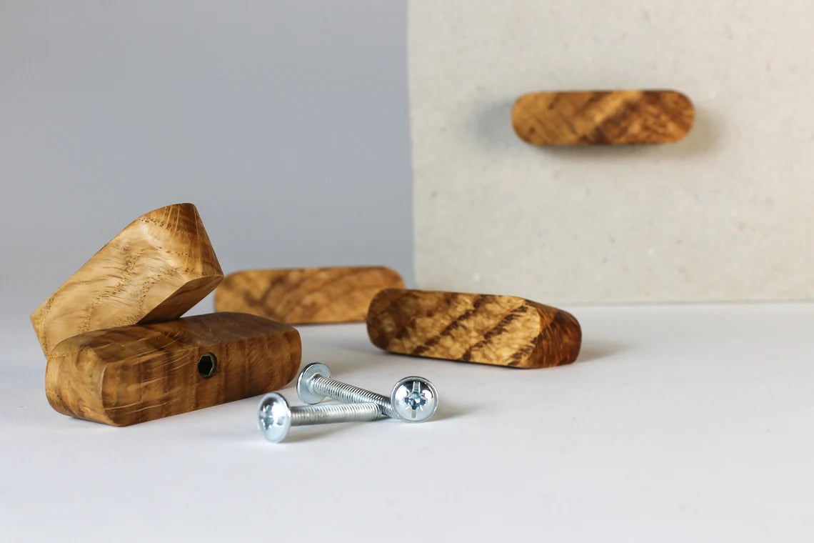 Alt Text: Set of wooden drawer knobs with a smooth natural finish.

